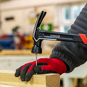 This is an image showing someone hitting a nail with a Timco Claw Hammer